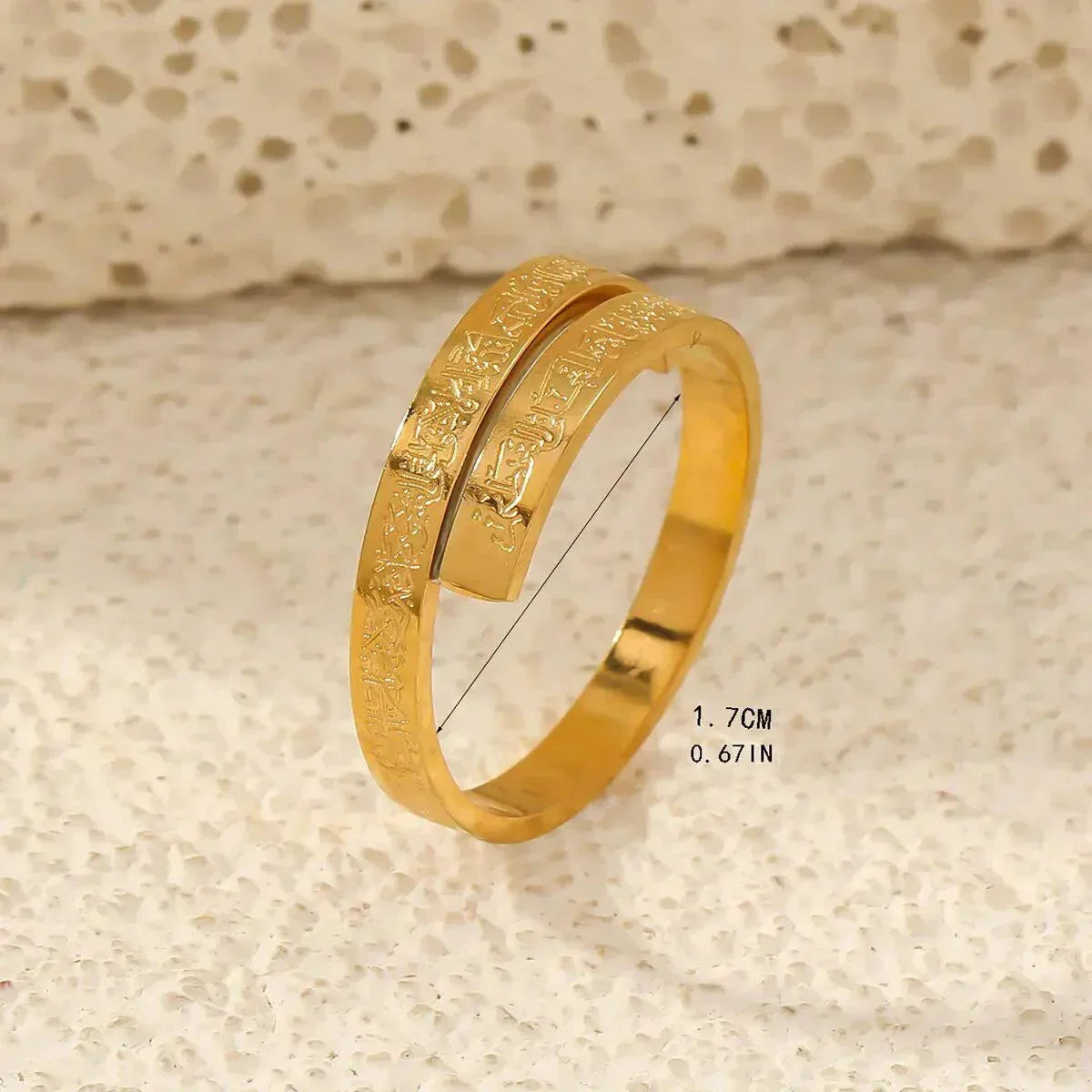 Gold Ayatul Kursi ring with Arabic inscription on textured background, Arabella Vibe jewelry