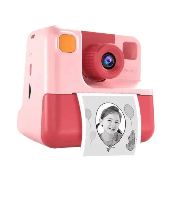 Pink and red digital instant camera printing black and white photo of smiling child with balloons